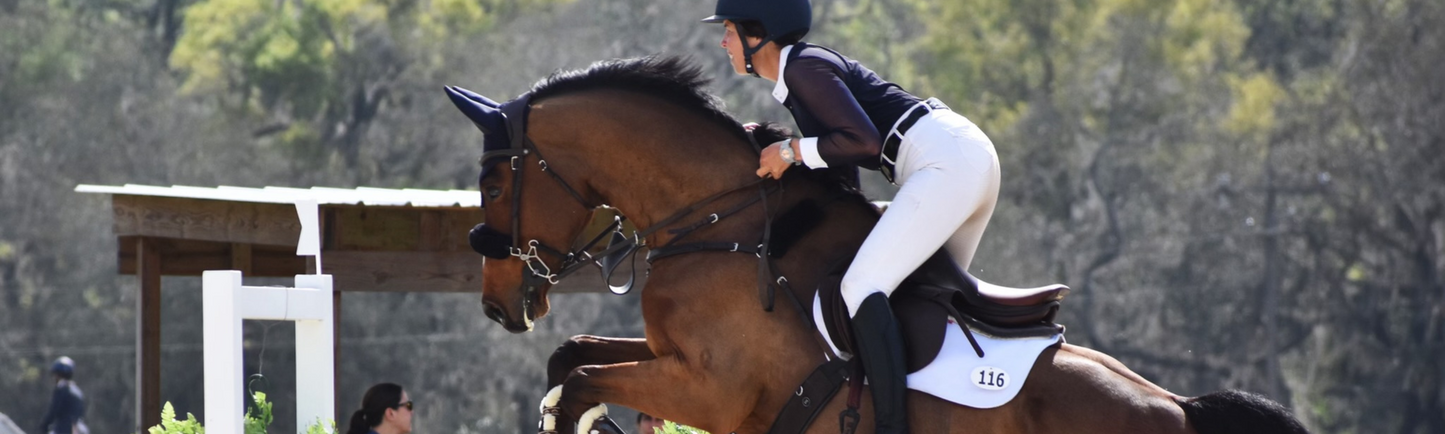 Sponsored rider and 5 star eventer, Meghan O'Donoghue, riding over a jump.