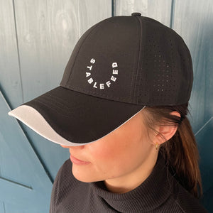Front of our black StableFeed cap with our logo stitched on the front left.