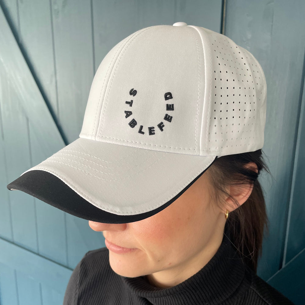Front of our white StableFeed cap with our logo stitched on the front left.