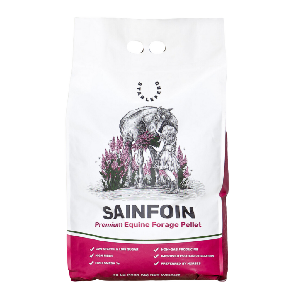 The Sainfoin Forage Pellet packaging is white with rich pink detailing, showing a horse and young girl happily together in a field of sainfoin.